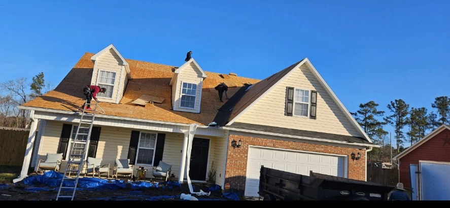 Luis Roofing crew installing a new roof in Fayetteville, NC