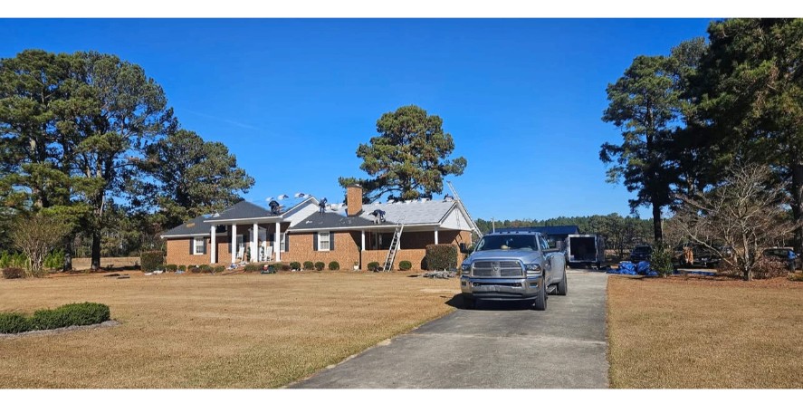 Roof replacement in progress on brick ranch home